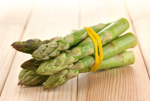 Useful asparagus close-up on wooden table on white background — Stock Photo, Image