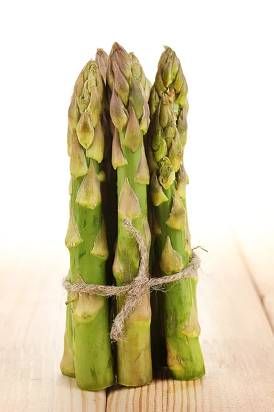 Useful asparagus on wooden table on white background — Stock Photo, Image