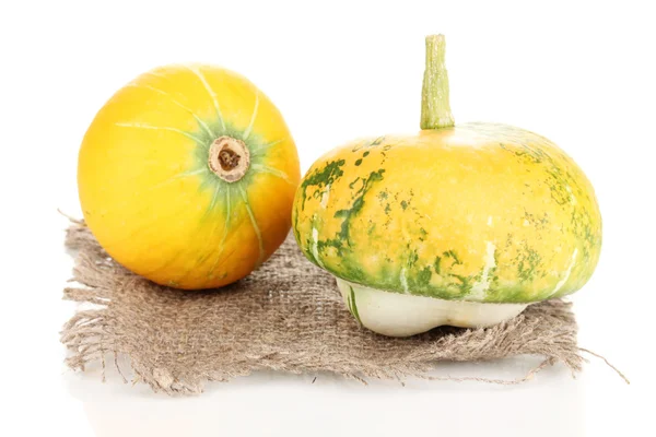 Two pumpkins on sackcloth isolated on white — Stock Photo, Image