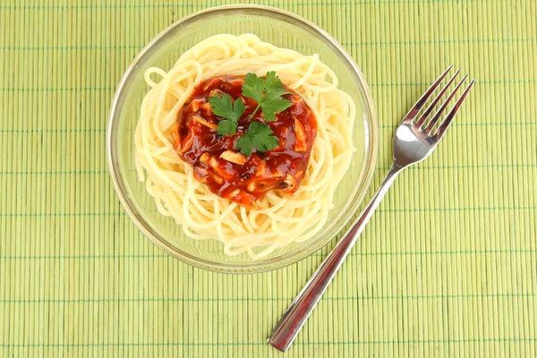 Italian spaghetti in plate on bamboo mat — Stock Photo, Image
