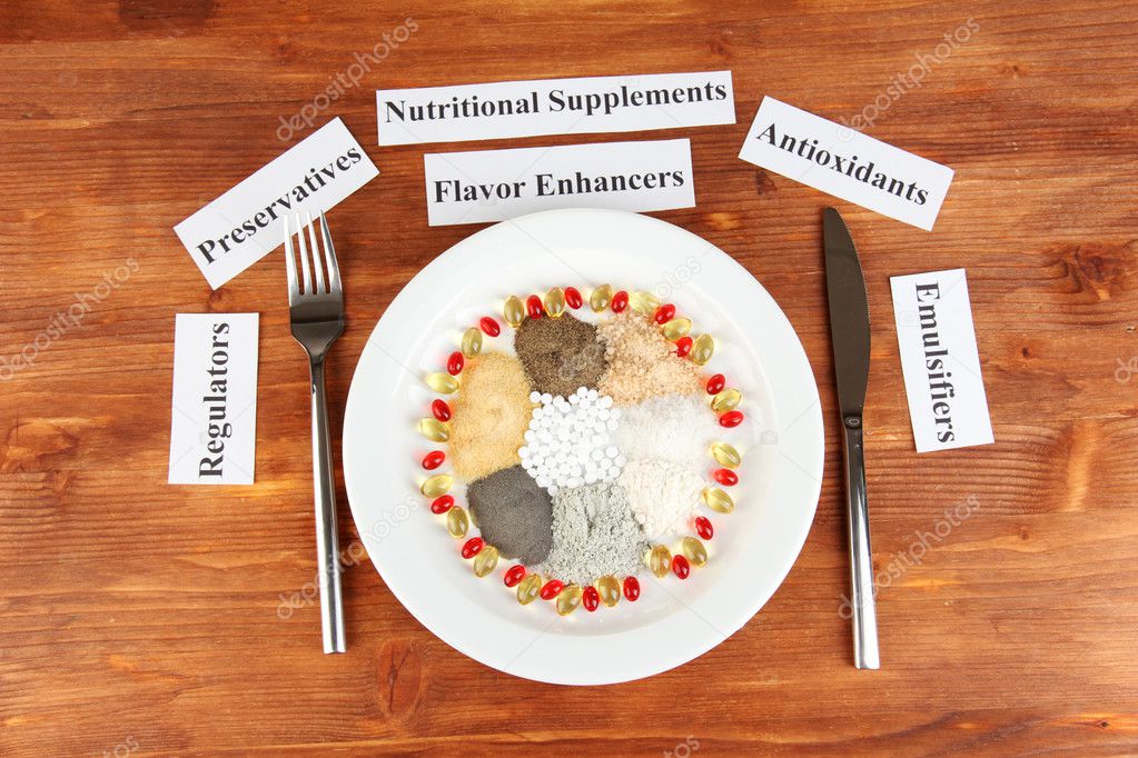 Nutritional supplements on wooden background close-up