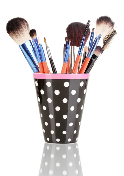 Makeup brushes in a black polka-dot cup isolated on white — Stock Photo, Image