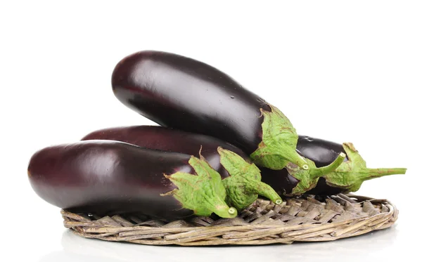 Fresh eggplants on wicker mat isolated on white — Stock Photo, Image