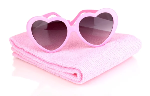 Pink heart-shaped sunglasses on towel isolated on white — Stock Photo, Image