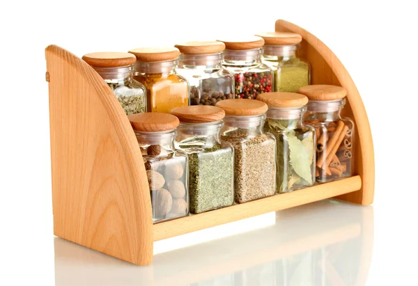 Powder spices in glass jars on wooden shelf isolated on white — Stock Photo, Image