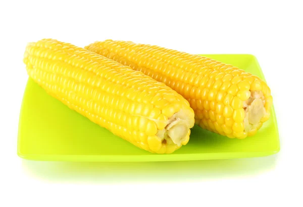 Boiled corn isolated on white on the green plate — Stock Photo, Image