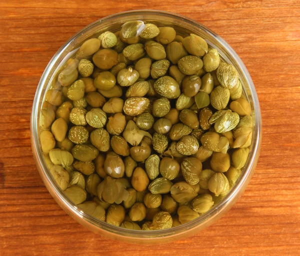 Jar with capers on wooden background — Stock Photo, Image