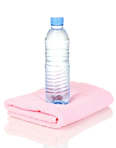 Plastic bottle of water on towel isolated on white — Stock Photo, Image