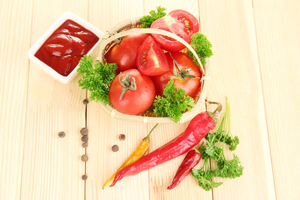 Still life tomatoes ketchup and herbs on wooden table — Stock Photo, Image
