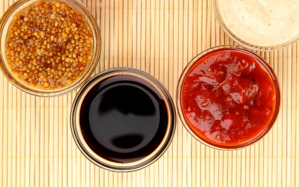 Various sauces on bamboo mat — Stock Photo, Image