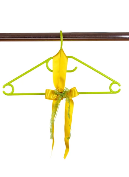Beautiful yellow bow hanging on wooden hanger isolated on white — Stock Photo, Image