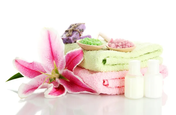 Towels with lily, aroma oil, soap and sea salt isolated on white — Stock Photo, Image