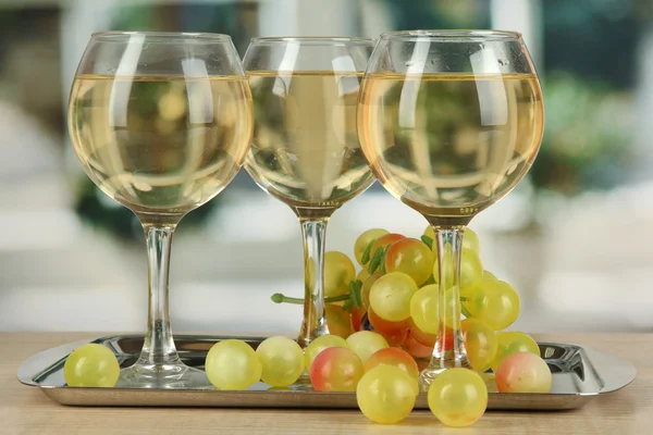 White wine in glass on salver on window background — Stock Photo, Image