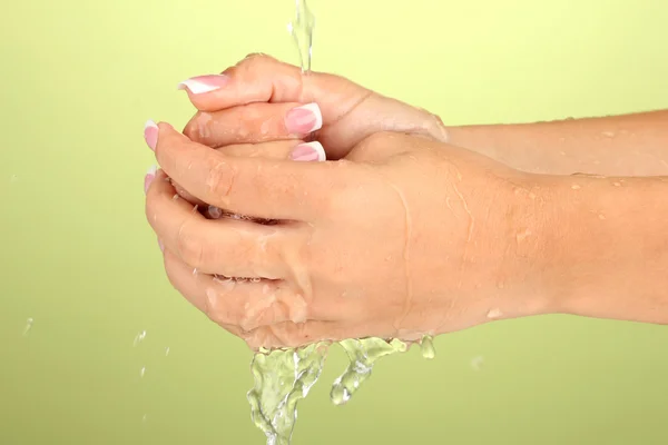 Washing woman's hands on green background close-up — Stock Photo, Image
