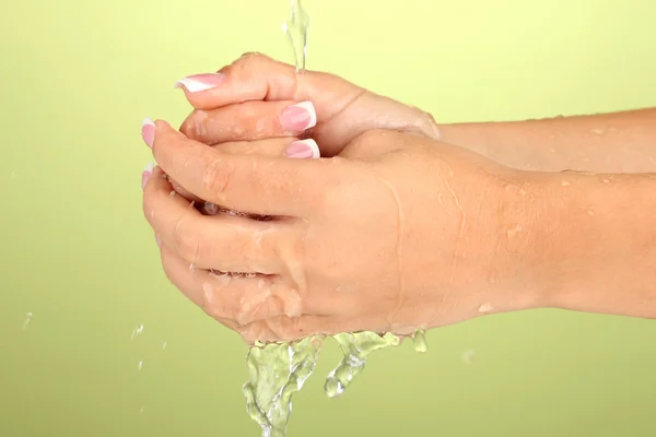 Laver les mains de la femme sur fond vert gros plan — Photo