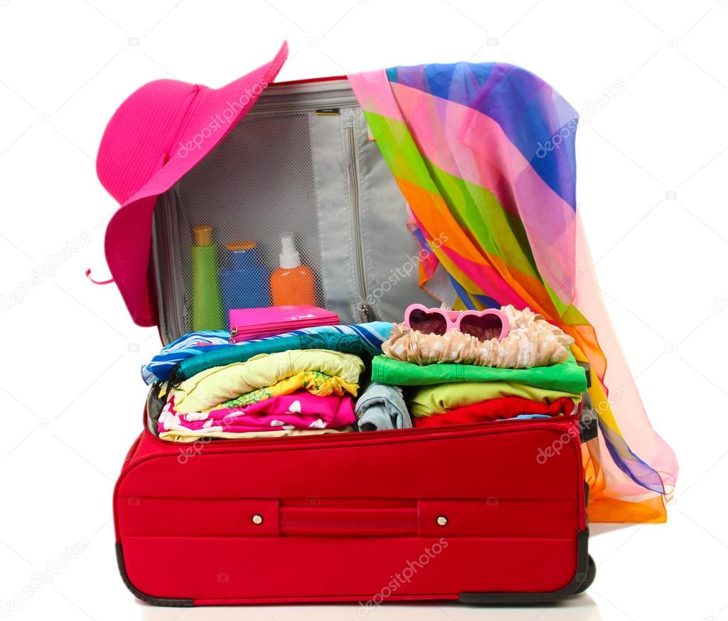 Red travel suitcase with personal belongings isolated on white