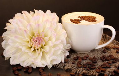 Latte on wooden table on brown background clipart