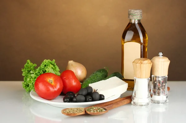 Ingredients for a Greek salad on brown background close-up — Stock Photo, Image