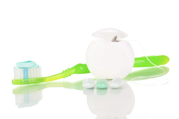 Toothbrush, chewing gum and dental floss isolated on white — Stock Photo, Image