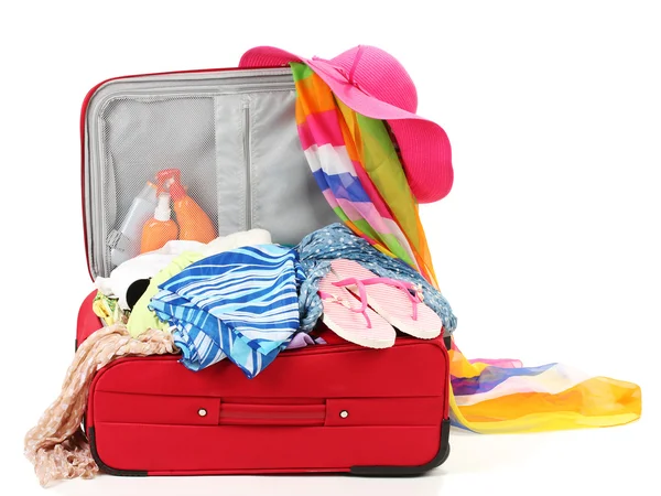 Suitcase with summer clothes, a hat and suntan isolated on white — Stock Photo, Image