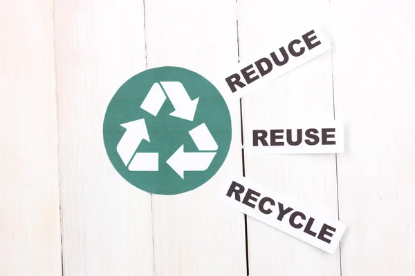 Recycling sign on wooden background — Stock Photo, Image