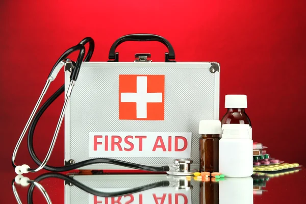 First aid box, on red background — Stock Photo, Image