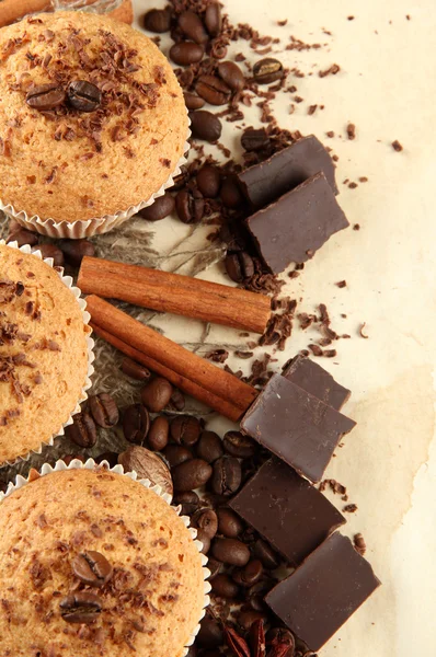 Sabrosos pasteles de magdalenas con chocolate, especias y semillas de café, sobre fondo beige —  Fotos de Stock