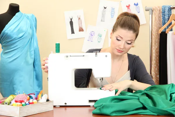 Beautiful young dressmaker in workroom — Stock Photo, Image