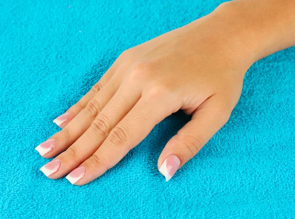 Woman's hand on blue terry towel, close-up — Stock Photo, Image
