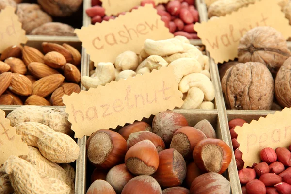 Assortment of tasty nuts in wooden box, close up — Stock Photo, Image