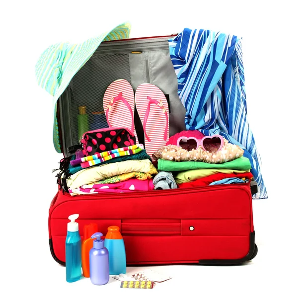 Red travel suitcase with personal belongings isolated on white — Stock Photo, Image