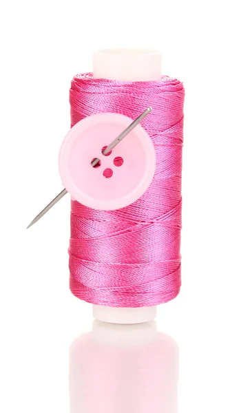 Pink bobbin with needle and buttons isolated on white — Stock Photo, Image