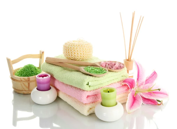 Towels with lily, aroma oil, candles and sea salt isolated on white — Stock Photo, Image