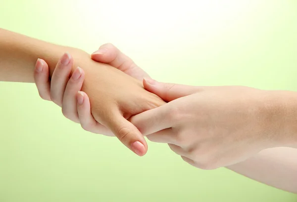 Hand massage, on green background — Stock Photo, Image