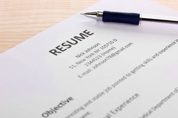 Closeup of resume with pen on wooden table — Stock Photo, Image