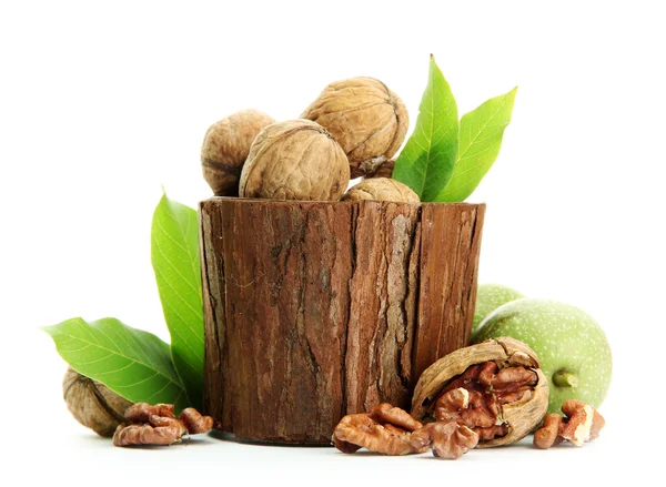 Vlašské ořechy se zelenými listy v woooden vázu, izolované na bílém — Stockfoto