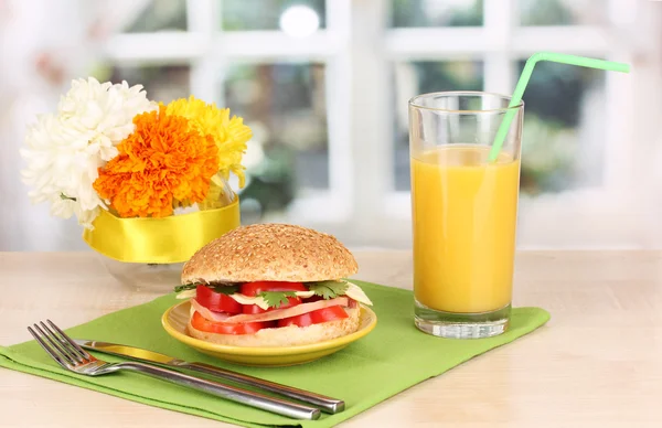 Smakelijk sandwich op kleurplaat op houten tafel op achtergrond van venster — Stockfoto