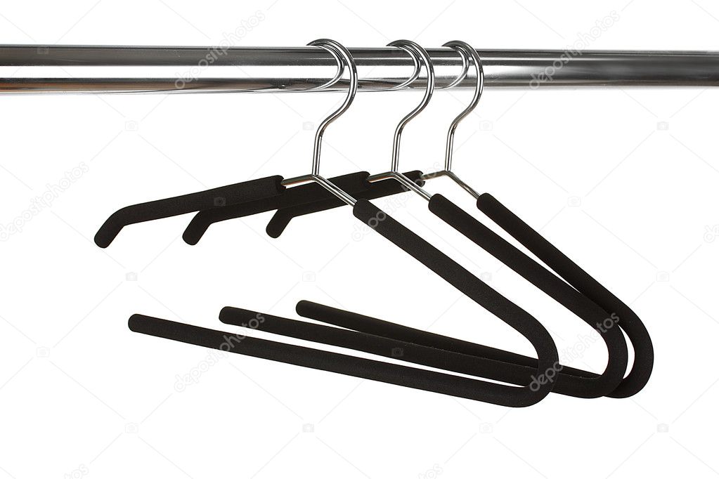 black clothes hangers on white background close-up