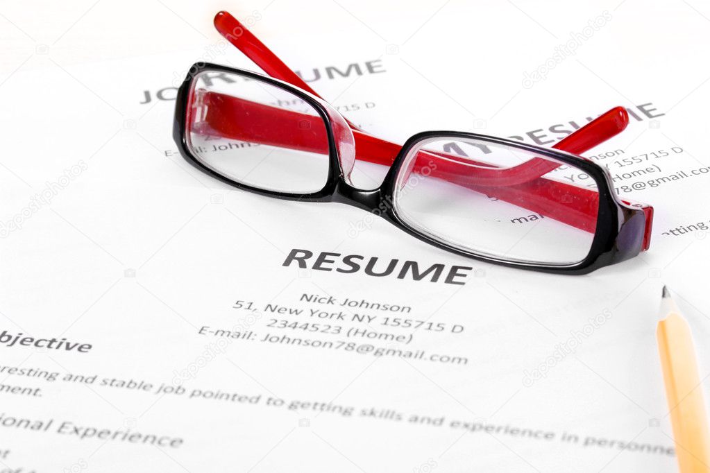 Closeup of resume with pencil and glasses on table