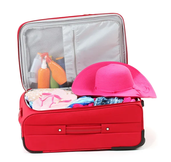 Suitcase with summer clothes, a hat and suntan isolated on white — Stock Photo, Image