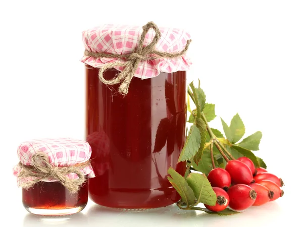 Jars with hip roses jam and ripe berries, isolated on white — Stock Photo, Image