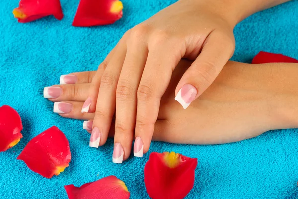 Woman's hands on blue terry towel, close-up — Stock Photo, Image