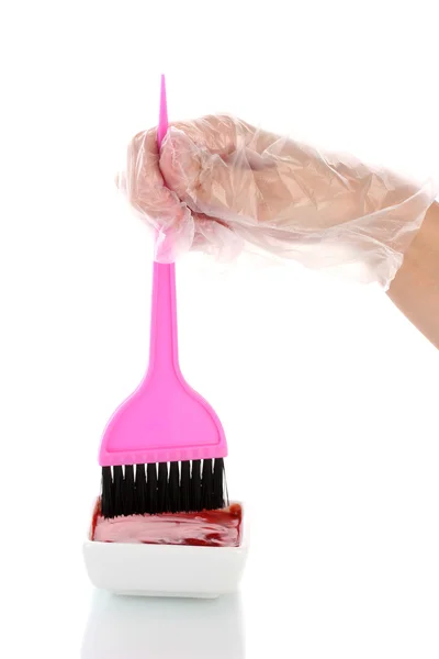 Woman's hand in a glove dips the brush in hair dye, on white background — Stock Photo, Image