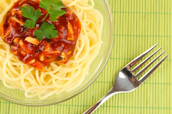 Italian spaghetti in plate on bamboo mat — Stock Photo, Image