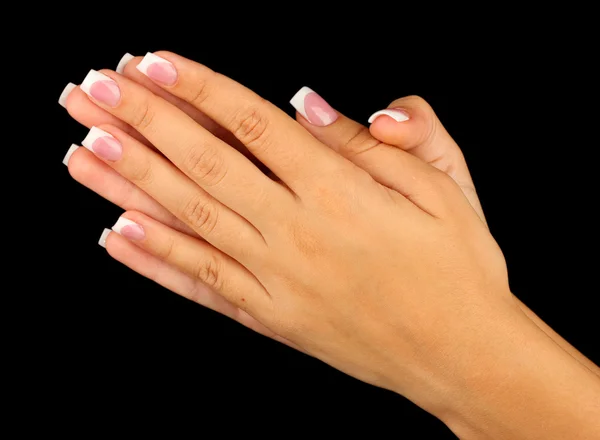 Beautiful woman's hands with french manicure on black background — Stock Photo, Image