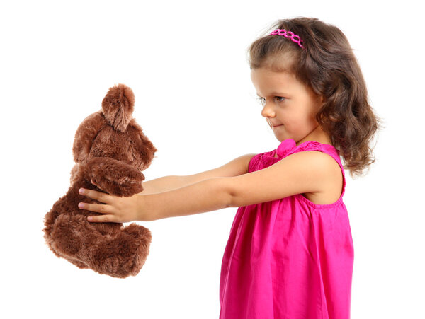 Beautiful little girl with toy bear isolated on white
