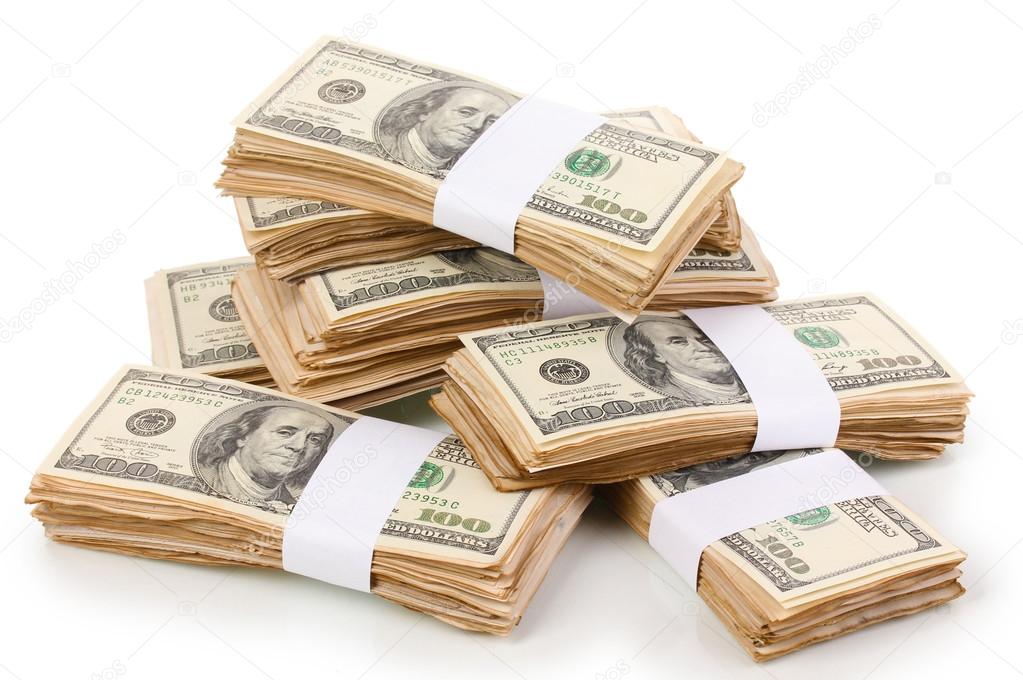 Stacks of one hundred dollars banknotes close-up isolated on white