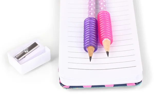 Pencils, pencil sharpener and notepad isolated on white — Stock Photo, Image