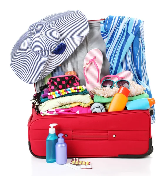 Red travel suitcase with personal belongings isolated on white — Stock Photo, Image