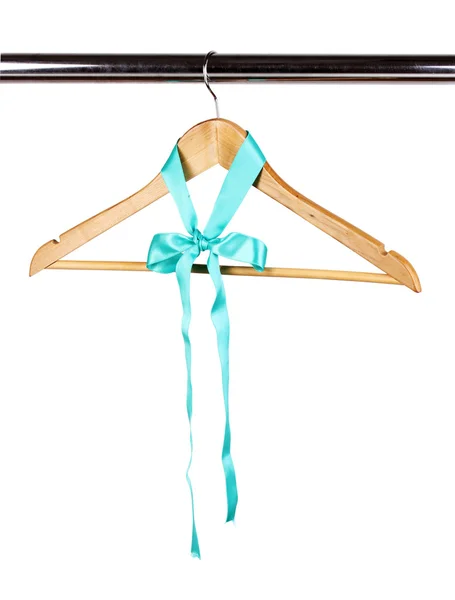 Beautiful turquoise bow hanging on wooden hanger isolated on white — Stock Photo, Image